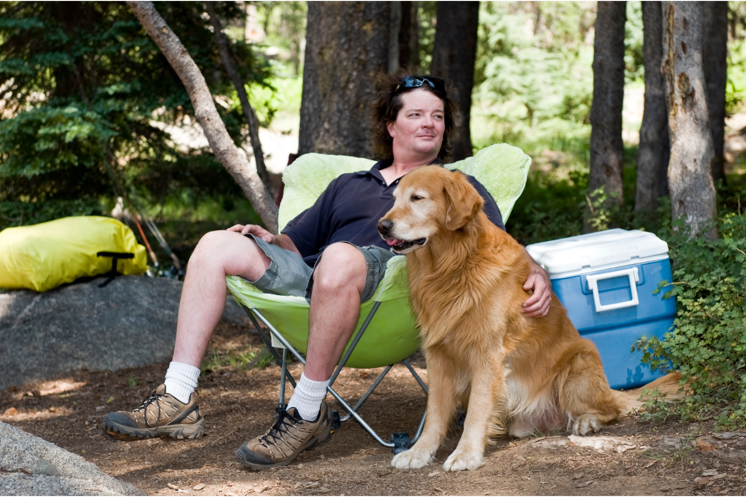 man solo camping with golden retriever