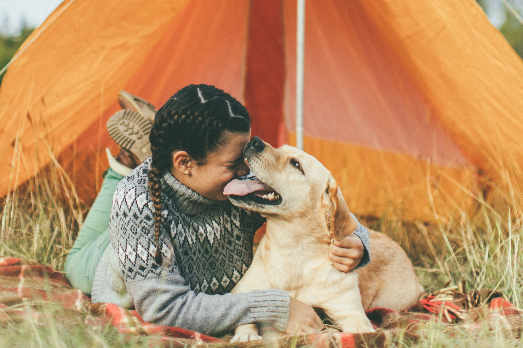 woman in tent with dog